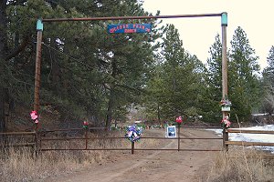 Flowers and cards on gate at entrance to Berg Ranch